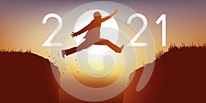 Carte de voeux montrant un homme sautant entre deux rochers pour passer en 2021. photo